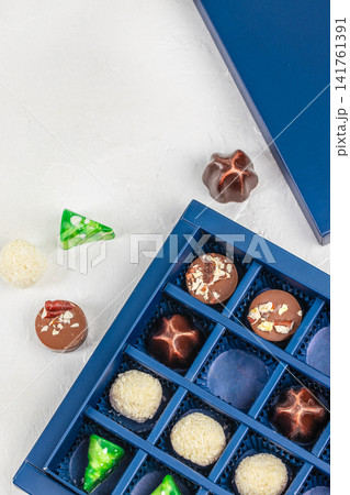 Assorted Handmade Chocolates in Luxury Gift Box on White Background Top View Assorted Handmade Chocolates in Luxury Gift Box on White Background Top View 141761391