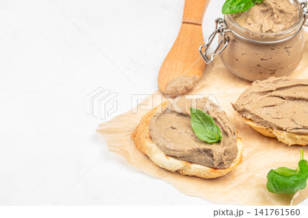 Homemade chicken liver pate sandwiches with fresh basil on light background 141761560
