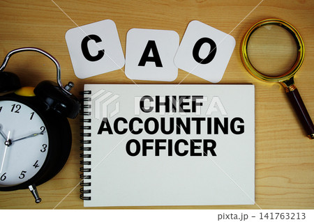 CAO Chief Accounting Officer text written on notepad with magnifying glass and alarm clock on wooden background CAO Chief Accounting Officer text written on notepad with magnifying glass and alarm clock on wooden background 141763213