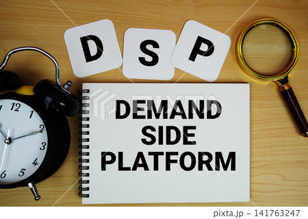 DSP Demand Side Platform text written on notepad with magnifying glass and alarm clock on wooden background 141763247