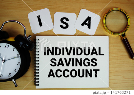 ISA Individual Savings Account text written on notepad with magnifying glass and alarm clock on wooden background ISA Individual Savings Account text written on notepad with magnifying glass and alarm clock on wooden background 141763271