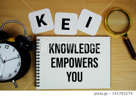 KEY Knowledge Empowers You text written on notepad with magnifying glass and alarm clock on wooden background KEY Knowledge Empowers You text written on notepad with magnifying glass and alarm clock on wooden background 141763274