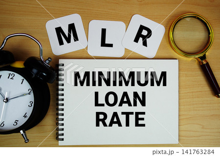 MLR Minimum Loan Rate text written on notepad with magnifying glass and alarm clock on wooden background MLR Minimum Loan Rate text written on notepad with magnifying glass and alarm clock on wooden background 141763284