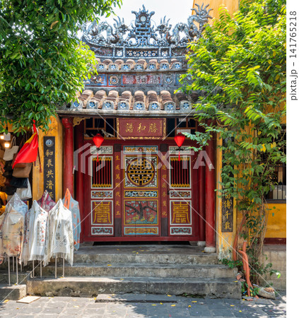 Historic entrance with traditional red doors and lanterns in Hoi An Ancient Town, Vietnam Historic entrance with traditional red doors and lanterns in Hoi An Ancient Town, Vietnam 141765218