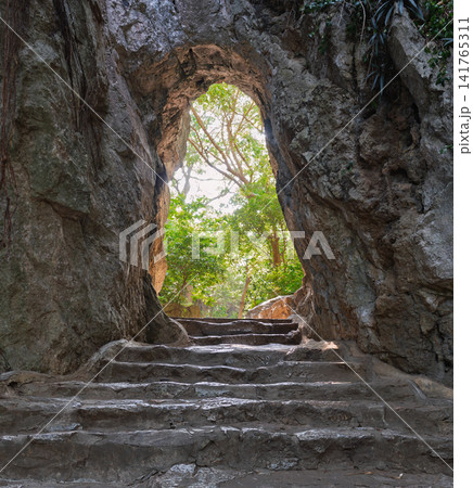 Stone staircase leading through a natural rock archway at the Marble Mountains in Da Nang, Vietnam Stone staircase leading through a natural rock archway at the Marble Mountains in Da Nang, Vietnam 141765311