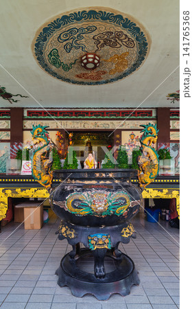 Ornate dragon incense burner and Laughing Buddha statue at Thean Hou Temple Kuala Lumpur Malaysia Ornate dragon incense burner and Laughing Buddha statue at Thean Hou Temple Kuala Lumpur Malaysia 141765368