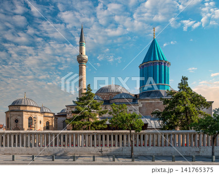 Iconic Mevlana Museum and Green Dome with its minaret under a vibrant blue sky in Konya, Turkey 141765375