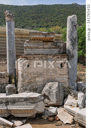 Ancient Roman ruins with weathered columns and carved stone fragments, Ephesus, Selcuk, Turkey Ancient Roman ruins with weathered columns and carved stone fragments, Ephesus, Selcuk, Turkey 141765450
