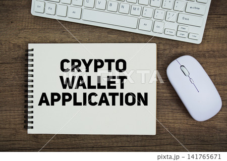 Crypto Wallet Application message with keyboard and optical mouse on wooden background Crypto Wallet Application message with keyboard and optical mouse on wooden background 141765671