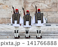 Traditional Evzones guards standing in ceremonial uniform in Athens, Greece. Iconic symbol of Greek history, heritage and national identity near the Hellenic Parliament. 141766888