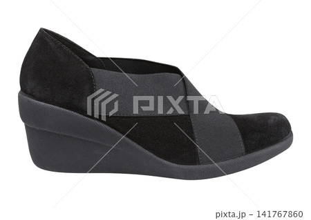 Black women suede wedge shoes isolated on white background. Comfortable casual slip-on pumps with elastic crossover straps, side view. Black women suede wedge shoes isolated on white background. Comfortable casual slip-on pumps with elastic crossover straps, side view. 141767860