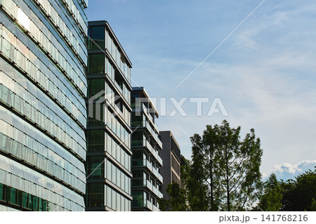 Modern office buildings with glass facades and blue sky Modern office buildings with glass facades and blue sky 141768216