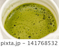 Close-up of freshly prepared matcha tea with smooth foam in a ceramic bowl. Traditional Japanese green tea ready to serve 141768532
