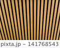 Close-up of decorative wooden slats with black gaps forming a clean geometric pattern. Natural wood texture background suitable for architecture, interior design, and abstract concepts 141768543