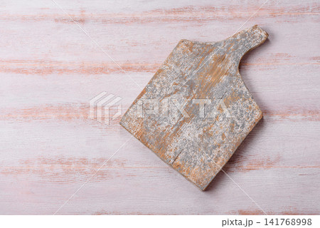 A square wooden cutting board for home food preparation. A wooden cutting board A square wooden cutting board for home food preparation. A wooden cutting board 141768998
