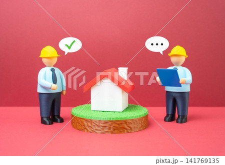 Engineers discussing a residential building project. Housing construction. Projects and design. Engineers discussing a residential building project. Housing construction. Projects and design. 141769135