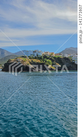 Scenic view of Bali village coastline on Crete island Greece with white hotel buildings on rocky cliff above blue sea water bay for Mediterranean travel concept Scenic view of Bali village coastline on Crete island Greece with white hotel buildings on rocky cliff above blue sea water bay for Mediterranean travel concept 141771607
