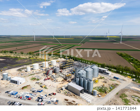 Construction of a modern agricultural grain terminal with wind turbines on the horizon 141771844