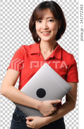 Asian woman holding laptop with confident smile in red shirt and standing against transparent background for business concept 141772363