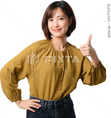 Asian woman thumbs up isolated portrait mustard blouse positive gesture confident smile with hand on waist against transparent background Asian woman thumbs up isolated portrait mustard blouse positive gesture confident smile with hand on waist against transparent background 141772378