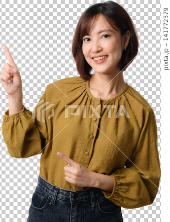 Asian woman pointing smiling mustard blouse isolated portrait, presenting welcoming gesture and confident expression for communication concept 141772379
