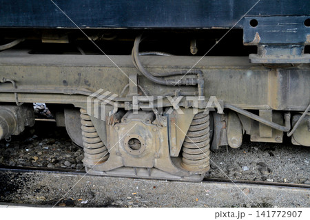 Train Undercarriage Close Up Showing Suspension Springs and Mechanical Parts Train Undercarriage Close Up Showing Suspension Springs and Mechanical Parts 141772907