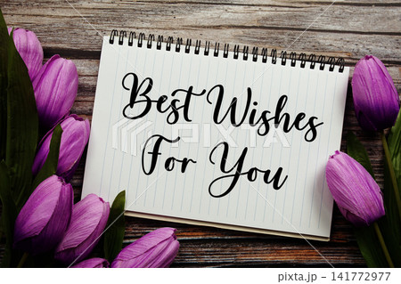 Best Wishes For You text written on notepad with flower decoration on wooden background Best Wishes For You text written on notepad with flower decoration on wooden background 141772977