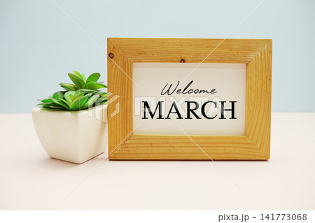 wooden frame with text "WELCOME MARCH" and small artificial plant wooden frame with text "WELCOME MARCH" and small artificial plant 141773068