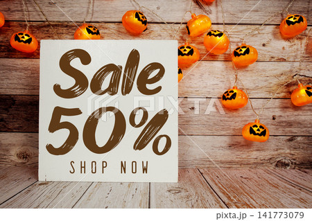 Halloween Sale 50% text with Halloween decoration on wooden background Halloween Sale 50% text with Halloween decoration on wooden background 141773079