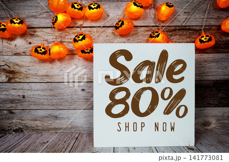 Halloween Sale 80% text with Halloween decoration on wooden background Halloween Sale 80% text with Halloween decoration on wooden background 141773081
