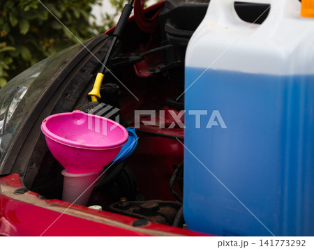 Windscreen wash fluid and funnel for auto car care Windscreen wash fluid and funnel for auto car care 141773292