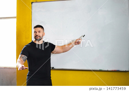 Fitness coach explaining workout program at gym Fitness coach explaining workout program at gym 141773459