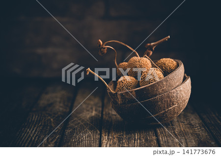 Rustic Still Life with Dried Fruits in Coconut Bowls 141773676