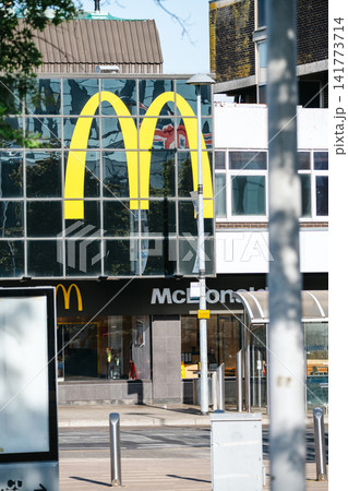 Corby, United Kingdom - August 2, 2026: Exterior of a McDonald's restaurant featuring the iconic Golden Arches logo in Corby town centre, Northamptonshire, England. Corby, United Kingdom - August 2, 2026: Exterior of a McDonald's restaurant featuring the iconic Golden Arches logo in Corby town centre, Northamptonshire, England. 141773714