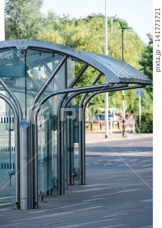 Modern glass bus stop shelter on urban street in England Modern glass bus stop shelter on urban street in England 141773721