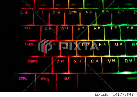 Top view of colorful RGB backlit keyboard glowing with vibrant LED lighting, showcasing modern computer hardware, gaming technology, digital workspace and neon illumination theme Top view of colorful RGB backlit keyboard glowing with vibrant LED lighting, showcasing modern computer hardware, gaming technology, digital workspace and neon illumination theme 141773842