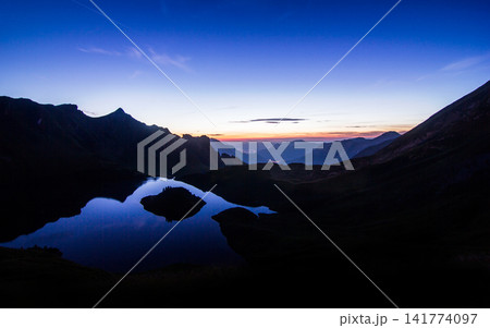 Mountain Lake at Blue Hour with Alpine Silhouettes Mountain Lake at Blue Hour with Alpine Silhouettes 141774097