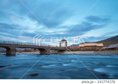 Wooden Bridge Over Mountain River at Blue Hour 141774176