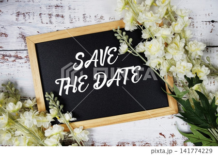 Save The Date text with flowers decoration on wooden background Save The Date text with flowers decoration on wooden background 141774229