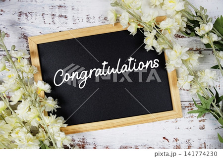 Congratulations text with flowers decoration on wooden background 141774230