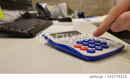 Calculator on Desk: Close-up of Office Work Essentials Calculator on Desk: Close-up of Office Work Essentials 141774319