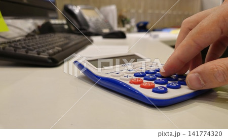 Close-Up of a Calculator Being Used in an Office Setting Close-Up of a Calculator Being Used in an Office Setting 141774320