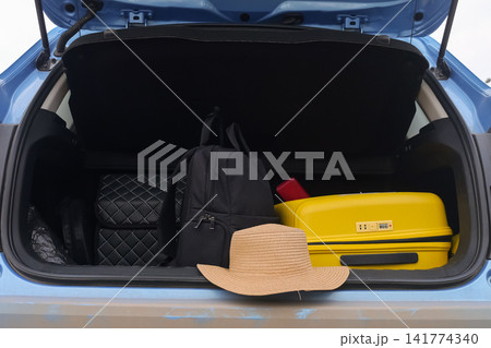 Yellow Suitcase And Backpack Inside Trunk With Straw Hat Nearby, Organized Packing Visible, Car Ready For Departure Toward Lakeside, Practical Road Preparation And Compact Storage Showcased Yellow Suitcase And Backpack Inside Trunk With Straw Hat Nearby, Organized Packing Visible, Car Ready For Departure Toward Lakeside, Practical Road Preparation And Compact Storage Showcased 141774340