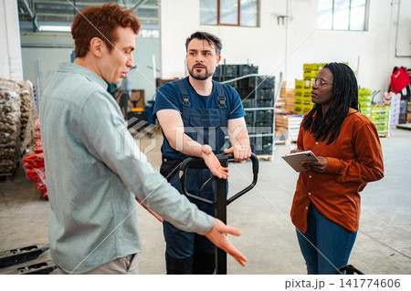 Warehouse colleagues having serious discussion about logistics problem Warehouse colleagues having serious discussion about logistics problem 141774606