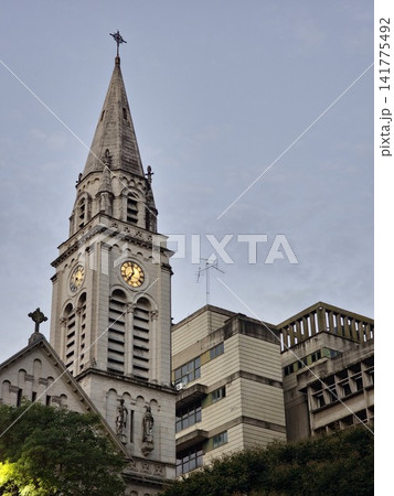Buenos Aires, Argentina - March 28, 2026: Historic Church Spire and Glowing Clock at Dusk Buenos Aires, Argentina - March 28, 2026: Historic Church Spire and Glowing Clock at Dusk 141775492