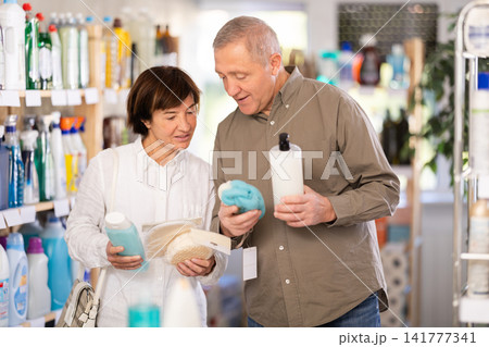 Husband and wife choose shower gel and washcloths 141777341