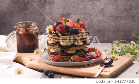 Pancakes with fruits and chocolate sauce 141777830