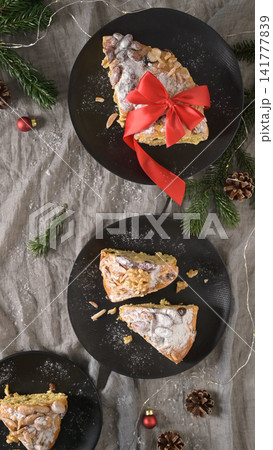 Festive Bolo Rainha slices on dark plates Festive Bolo Rainha slices on dark plates 141777839