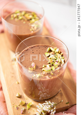 Two elegant glasses of smooth chocolate dessert Two elegant glasses of smooth chocolate dessert 141777847