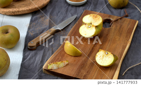 Golden Apples and Cinnamon on a Rustic Table Golden Apples and Cinnamon on a Rustic Table 141777933